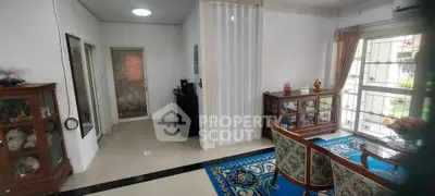 Elegant living room with decorative cabinets and large window view