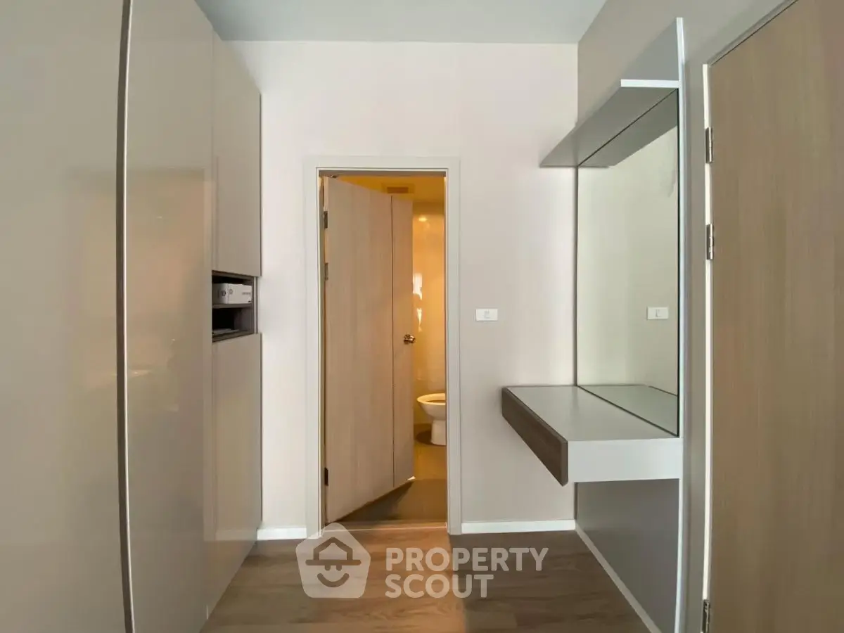 Modern apartment interior with sleek storage and bathroom view