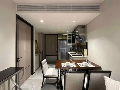 Modern kitchen with dining area featuring sleek appliances and elegant decor.