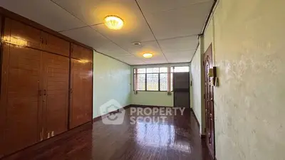 Spacious empty room with wooden floors and built-in wardrobe, ideal for customization.