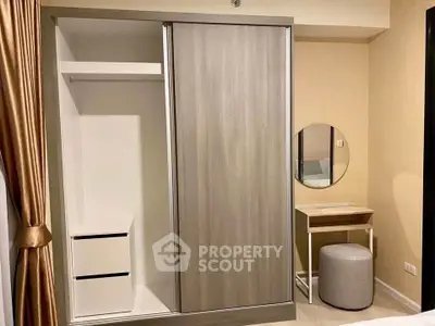 Modern bedroom with sleek wardrobe and stylish vanity area