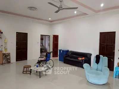 Spacious living room with modern furniture and ceiling fan