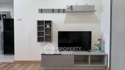 Modern living room with sleek TV stand and decorative shelves, perfect for stylish urban living.