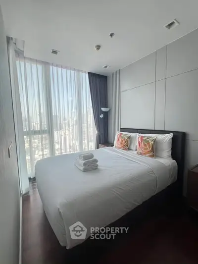 Modern bedroom with large windows and stylish decor