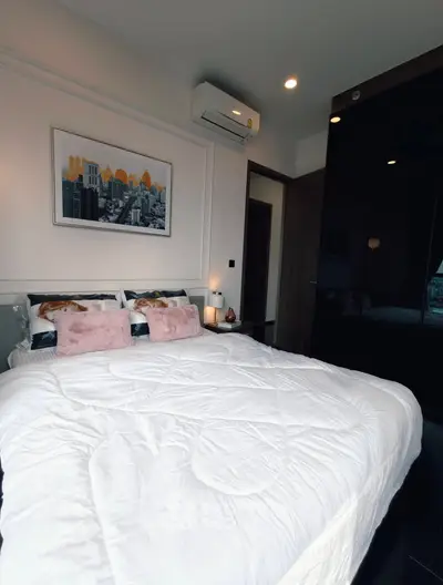 Modern bedroom with stylish decor and air conditioning in a contemporary apartment.