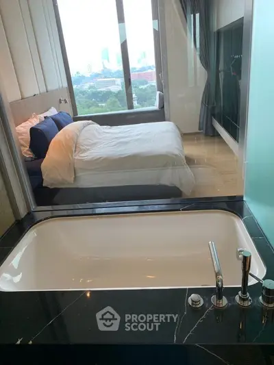 Luxurious bedroom with a modern bathtub and stunning city view, perfect for relaxation and comfort.