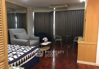 Cozy bedroom with elegant wooden flooring and modern furniture in a stylish apartment.