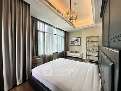 Luxurious bedroom with elegant chandelier and floor-to-ceiling windows in modern apartment.