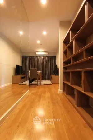 Spacious living room with wooden flooring and modern shelving unit