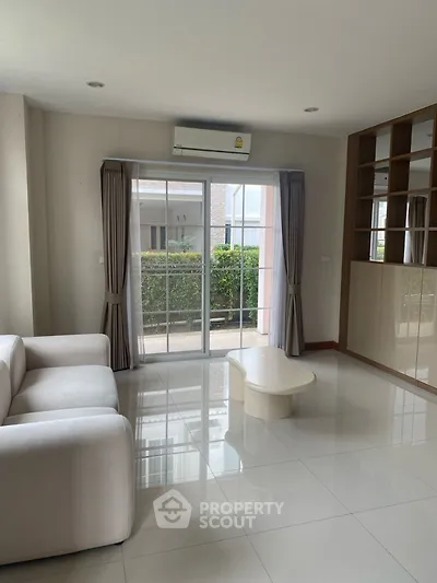 Spacious living room with modern sofa and large window view