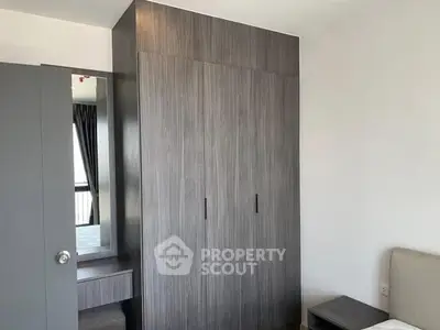 Modern bedroom with sleek wardrobe and natural light