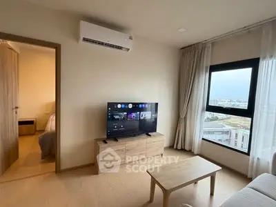 Modern living room with TV, wooden furniture, and large window with city view.