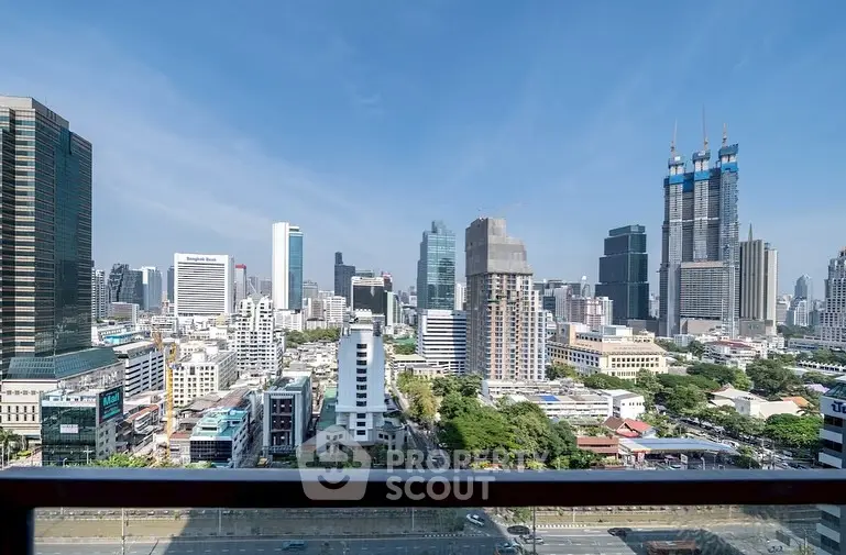 Stunning cityscape view from a high-rise balcony in a bustling urban area.