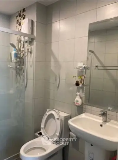 Modern bathroom with sleek fixtures and glass shower enclosure