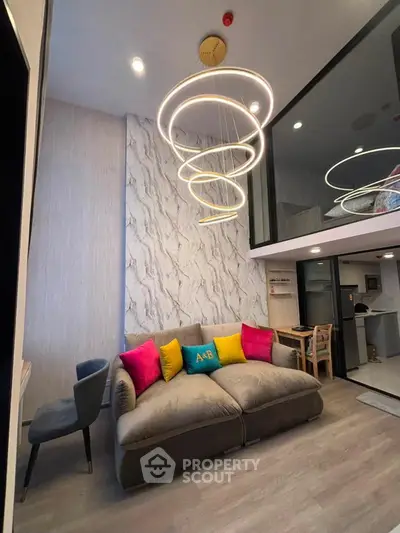 Modern living room with stylish lighting and cozy seating in a contemporary apartment.