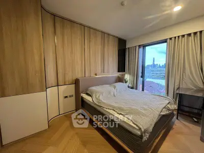 Modern bedroom with city view, featuring sleek wooden paneling and large window for natural light.