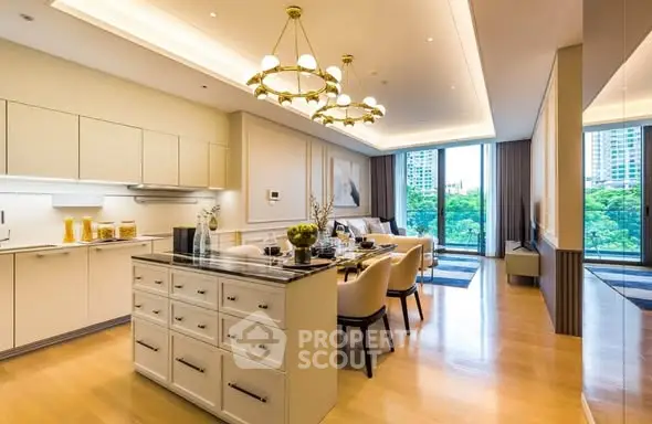 Luxurious open-plan kitchen and dining area with modern lighting and large windows.