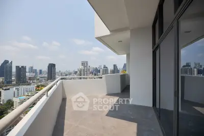 Spacious balcony with stunning city skyline view in modern high-rise apartment.