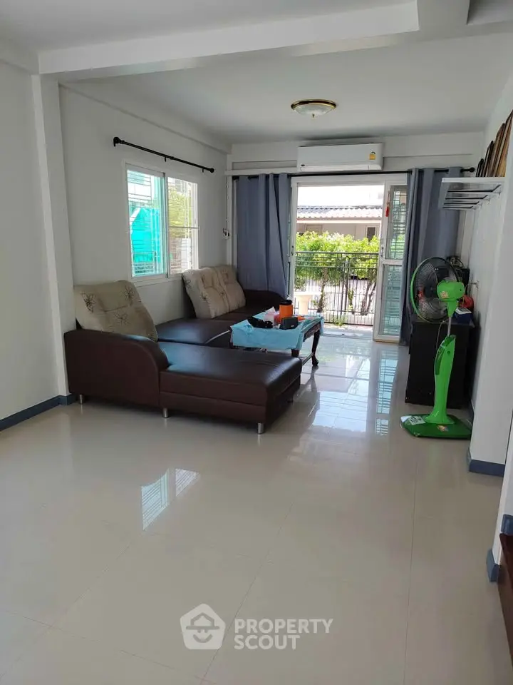 Spacious living room with modern furniture and large windows for natural light.