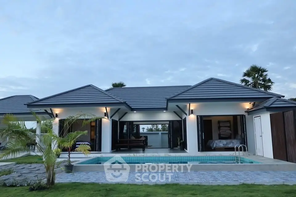 Stunning modern villa with pool and lush garden, perfect for luxury living.
