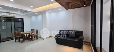 Spacious modern living room with elegant furniture and large windows for natural light.
