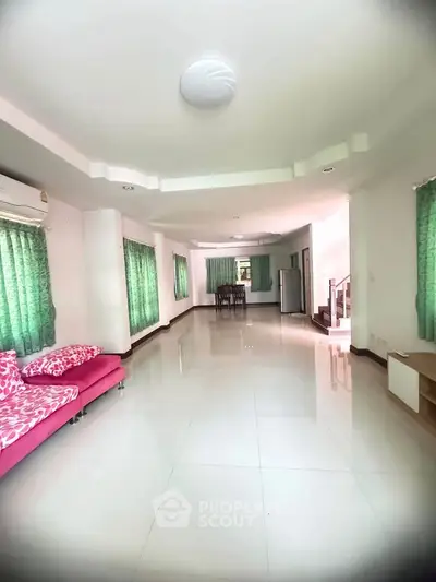 Spacious living room with modern decor and large windows for natural light