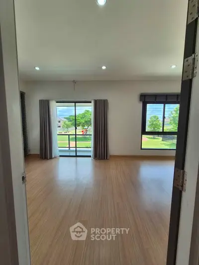 Spacious room with large windows and scenic view, perfect for natural light lovers.
