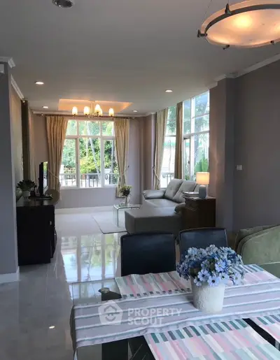 Spacious living room with elegant decor and large windows offering natural light.