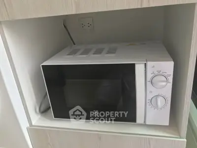 Modern kitchen with built-in microwave oven in sleek cabinetry