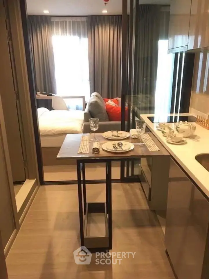 Modern studio apartment with compact kitchen and cozy living area