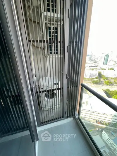 High-rise balcony with washing machine and city view, perfect for urban living convenience.