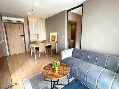 Modern living room with stylish furniture and open dining area in a contemporary apartment.