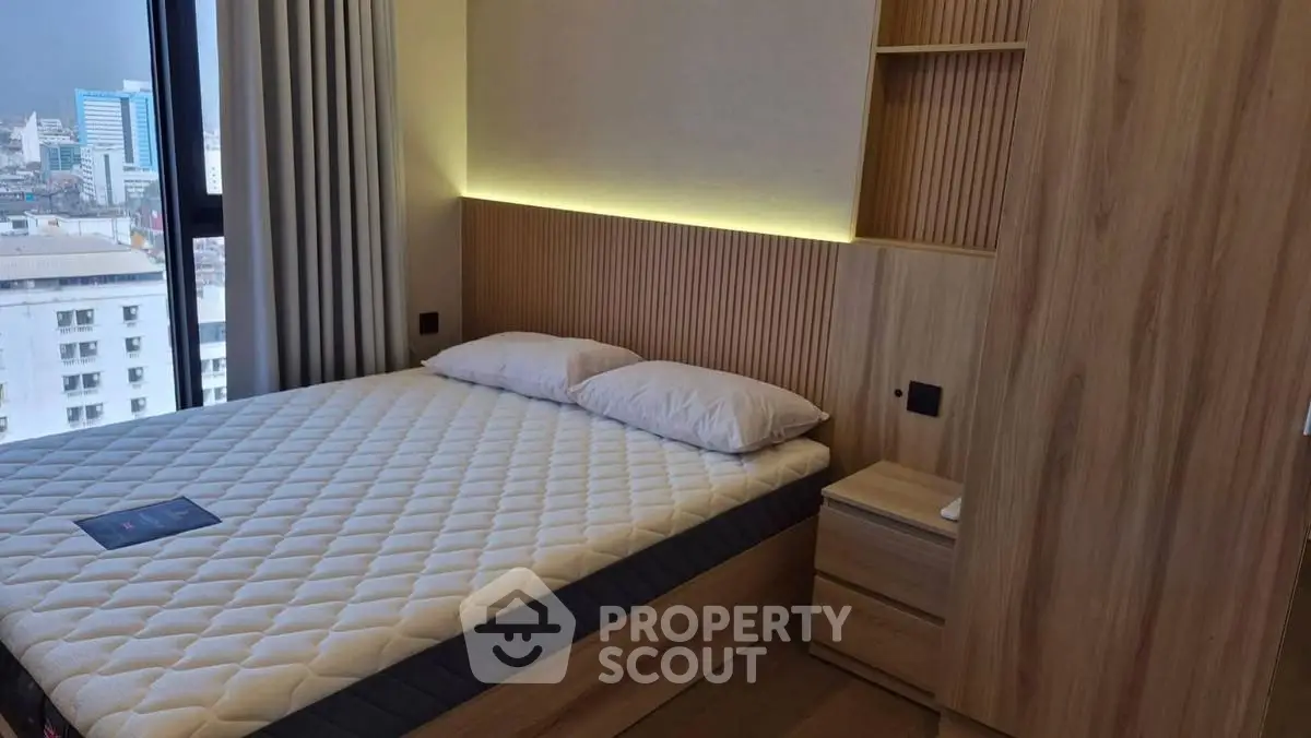 Modern bedroom with city view and stylish wooden accents