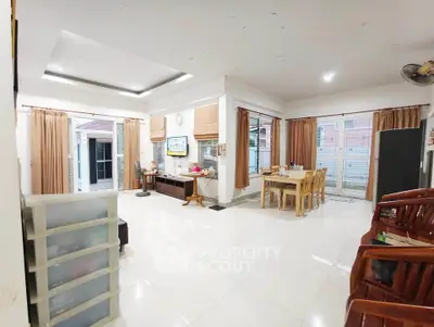 Spacious open-plan living and dining area with modern decor and ample natural light.