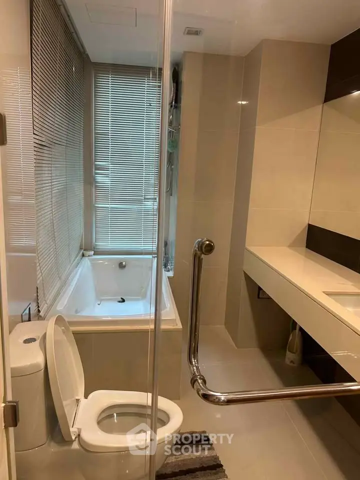 Modern bathroom with bathtub and sleek fixtures in a contemporary apartment.