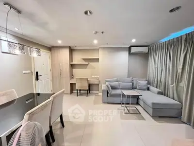 Spacious modern living room with elegant dining area and cozy sectional sofa.