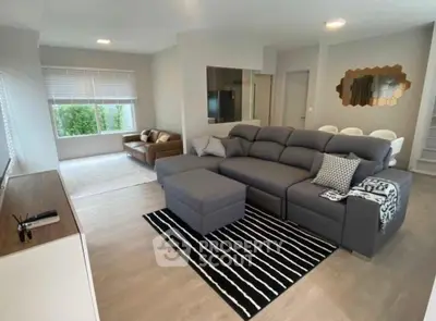 Spacious modern living room with stylish gray sectional sofa and chic decor