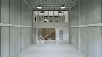 Spacious industrial-style interior with high ceilings and modern design.