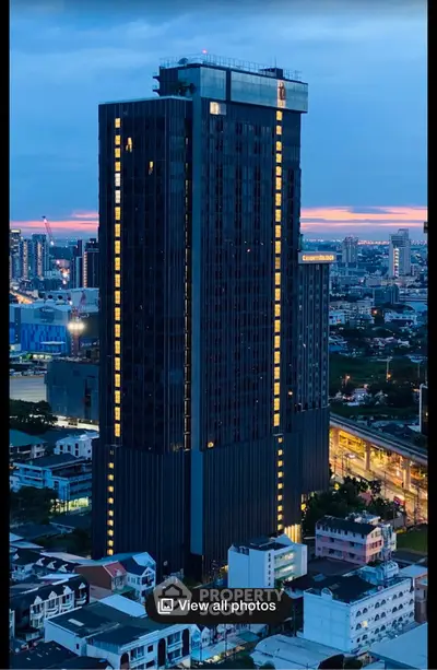 Stunning high-rise building with panoramic city views at dusk, perfect for urban living.