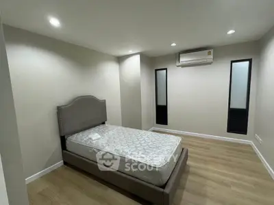 Spacious bedroom with modern design and air conditioning unit
