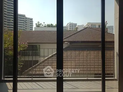 Charming balcony view with urban skyline and traditional rooftops, perfect for city living enthusiasts.