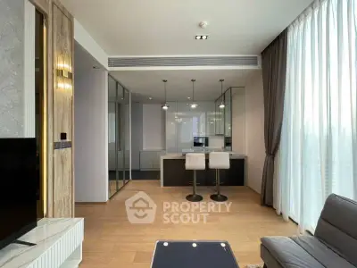 Modern open-plan living room with stylish kitchen and bar seating, featuring floor-to-ceiling windows.