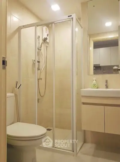 Modern bathroom with glass shower enclosure and sleek fixtures