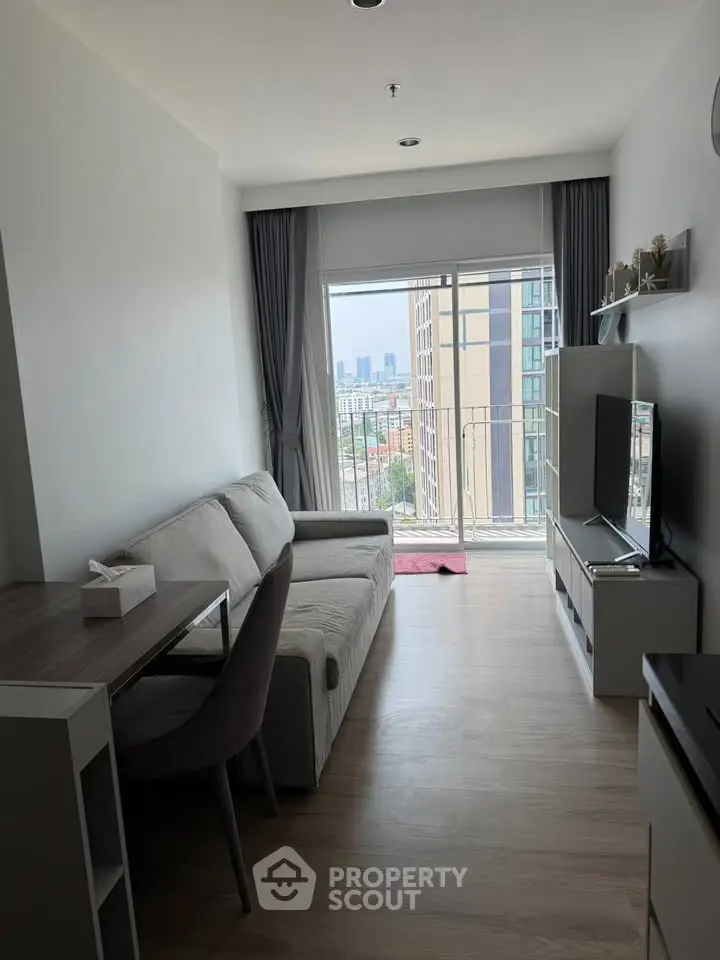 Modern living room with city view, featuring sleek furniture and natural light.