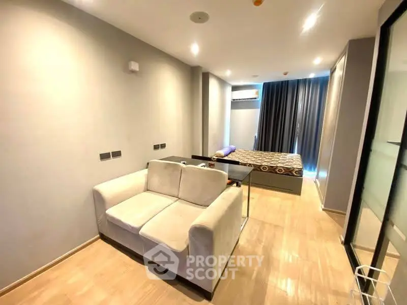 Modern studio apartment with cozy living area and stylish bedroom