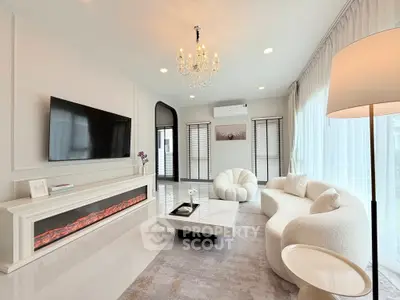 Luxurious modern living room with elegant chandelier and cozy seating area.