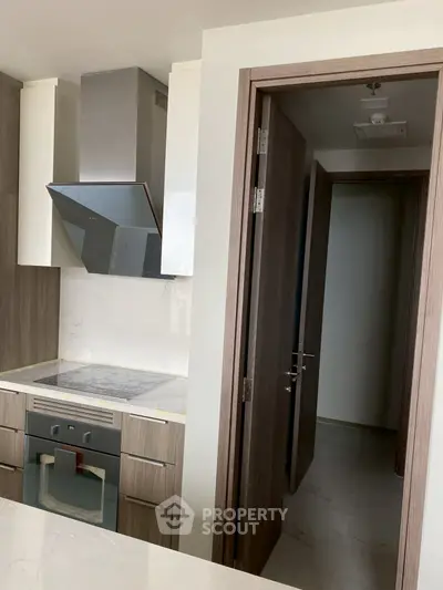 Modern kitchen with sleek cabinetry and built-in oven