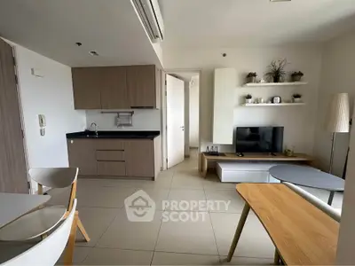 Modern open-layout living room with kitchenette and stylish decor