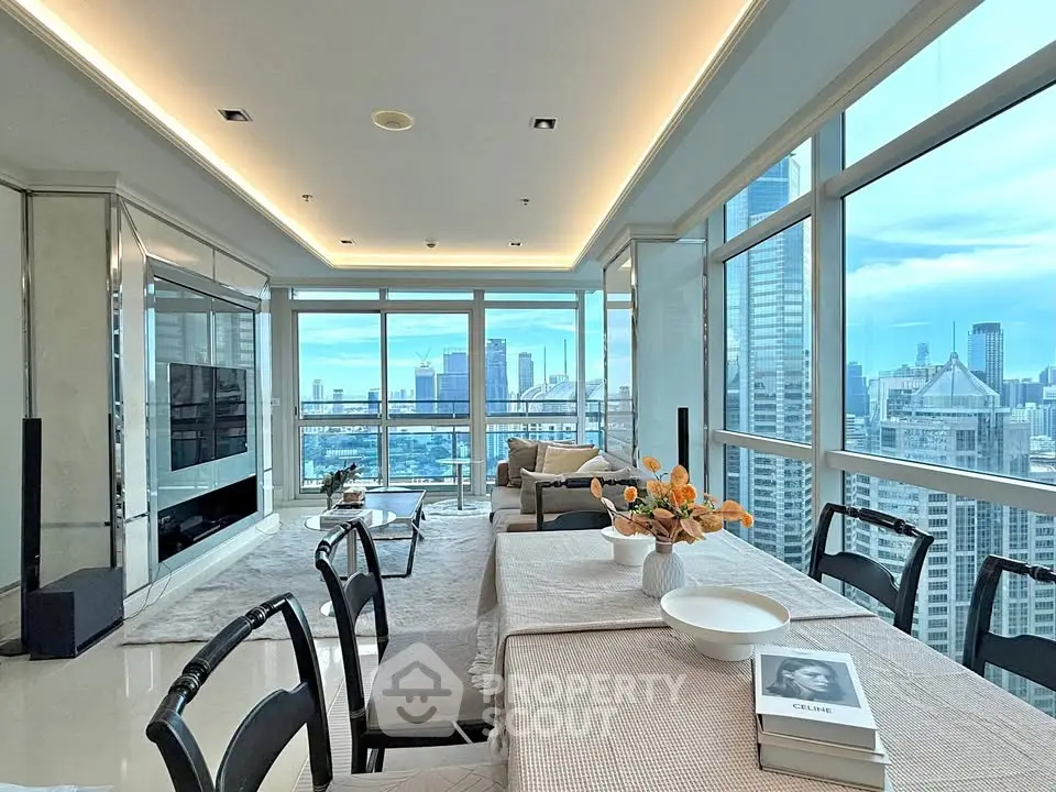 Luxurious high-rise living room with panoramic city views and elegant dining area.