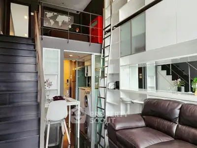 Modern loft apartment with sleek design, featuring a cozy living area and stylish kitchen.